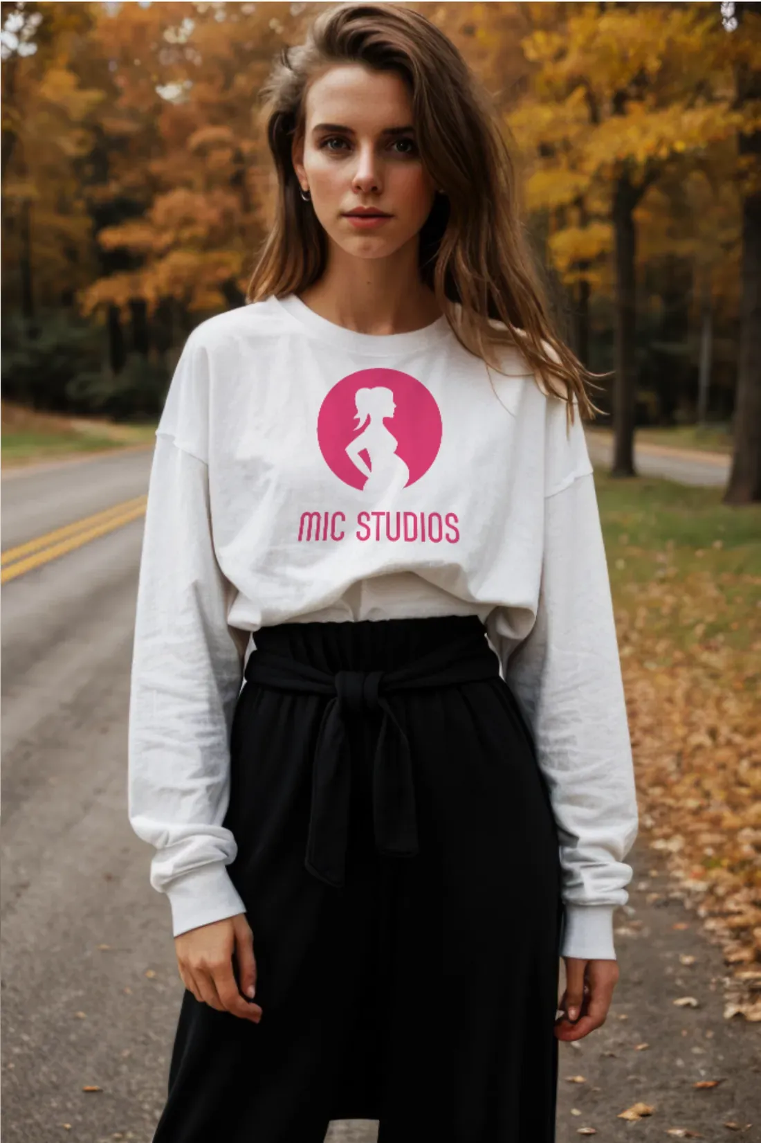 Woman in a white sweatshirt printed with the MIC Studios logo