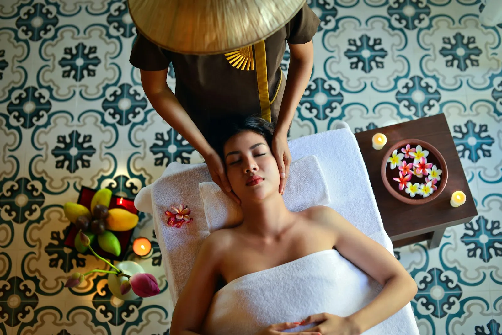 A client relaxing during a head massage in a calm wellness treatment room