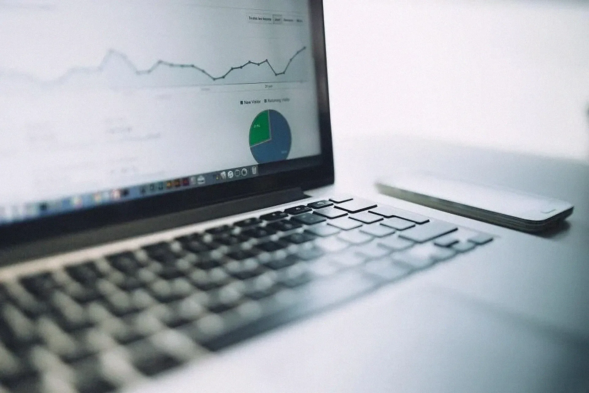 A laptop screen showing an analytics report with charts
