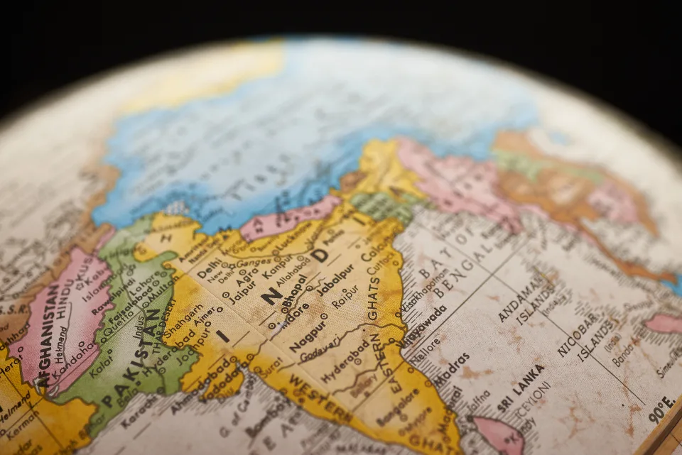 A globe turned to show India and the surrounding region