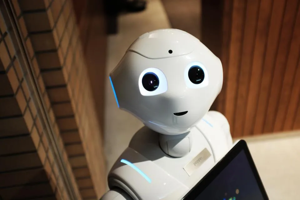 A friendly white robot with large eyes